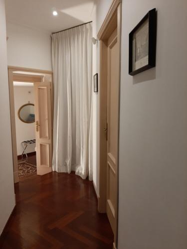 a room with a hallway with a white curtain and a door at Casa Vacanze Pizzofalcone 41b in Naples