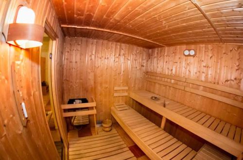 a wooden sauna with a bench in a room at Hotel Allvet in Drnovice