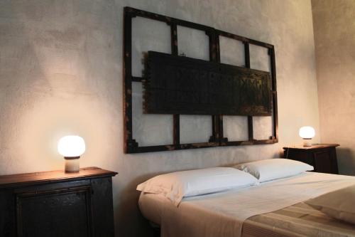 a bedroom with a bed with a mirror on the wall at Tuttaterra in Serra San Quirico