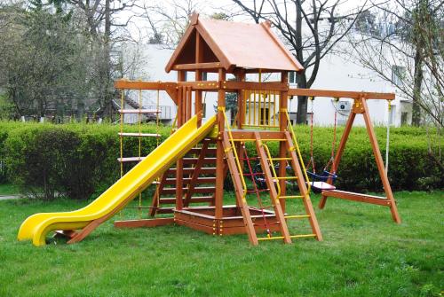 a playground with a slide and a play structure at Pushcha Congress Hotel in Kyiv