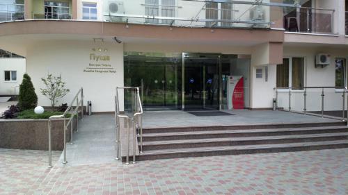 an entrance to a building with stairs and a revolving door at Pushcha Congress Hotel in Kyiv