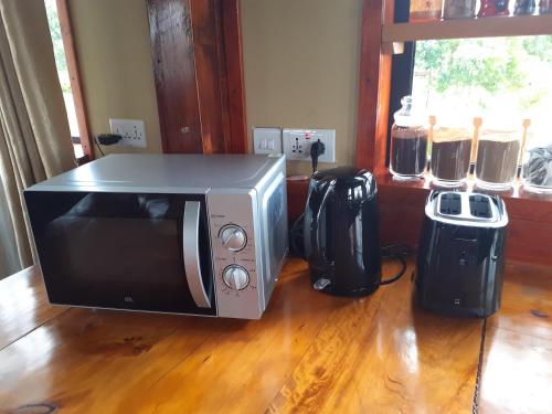 a microwave sitting on top of a wooden floor at Shamba lodge in Arusha
