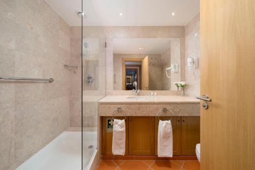 a bathroom with a tub and a sink and a shower at AL - Apartamento Vila Sol F5 Top Floor in Quarteira