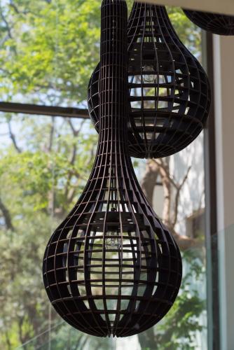 a black chandelier hanging in front of a window at Vivari Hotel and Spa by Mantis in Johannesburg