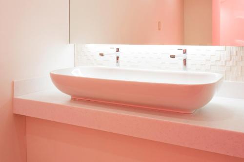 a white sink on a counter in a bathroom at Hotel Route One in Osaka