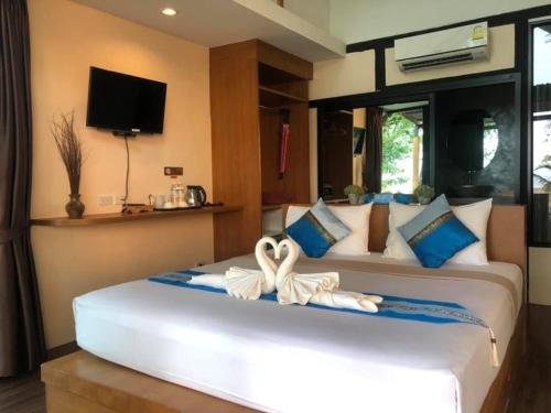 A bed or beds in a room at Mook Tamarind Resort