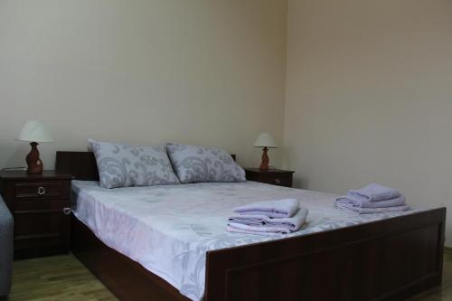 a bedroom with a bed with towels on it at Apartments Domovik ,Kirilla i Mefodiya, 5 in Mukacheve