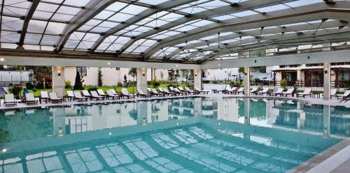 una gran piscina con sillas y un edificio en Long Beach Resort en Shkorpilovtsi
