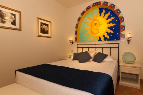 a bedroom with a bed with a painting on the wall at Summit Hotel in Gaeta