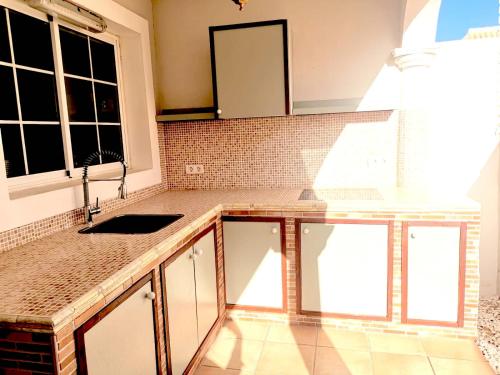 a kitchen with a sink and a counter top at Cloud Castle in Caleta De Fuste