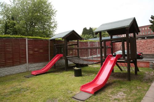 a playground with a red slide and a gazebo at The Fazeley Inn in Fazeley