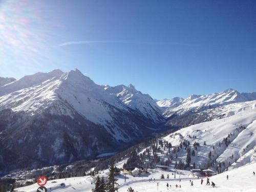 a group of people skiing down a snow covered mountain at Gasslihof in Sankt Anton am Arlberg