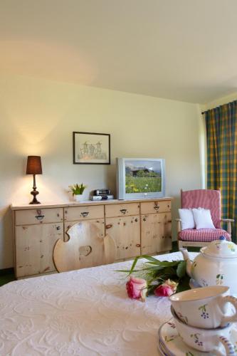 a bedroom with a bed with flowers on it at Landhaus Schwarz in Mieming