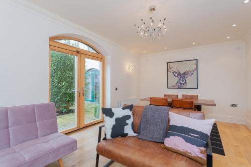 a living room with a couch and a table at Escape Ordinary at Castle Hume in Enniskillen