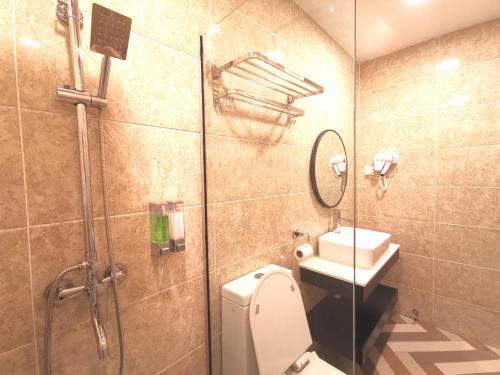 a bathroom with a shower and a toilet and a sink at HotSpot @ City Centre by SSVC in Kota Kinabalu