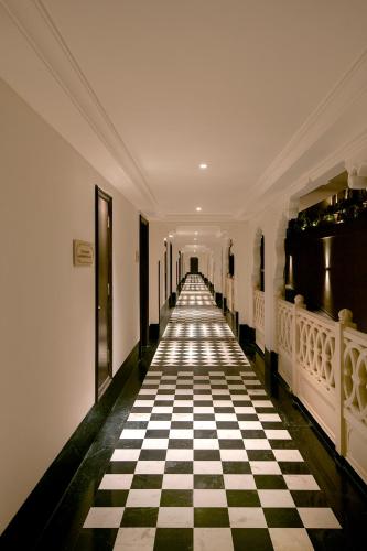 a hallway with a black and white checkered floor at Aurika, Udaipur - Luxury by Lemon Tree Hotels in Udaipur