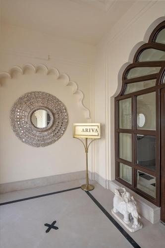 a room with a mirror and a sign on the wall at Aurika, Udaipur - Luxury by Lemon Tree Hotels in Udaipur