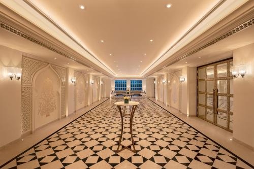 a hallway with a table in the middle of a building at Aurika, Udaipur - Luxury by Lemon Tree Hotels in Udaipur