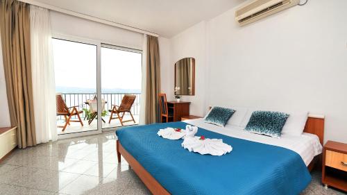 a hotel room with a bed with towels on it at Apartment Villa Lidija in Lovran