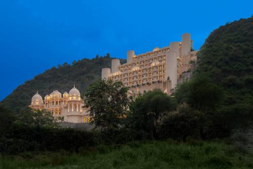 a large building sitting on top of a hill at Aurika, Udaipur - Luxury by Lemon Tree Hotels in Udaipur