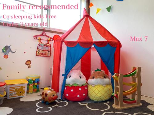 two stuffed animals sitting in a circus tent at Kamata Ann in Tokyo