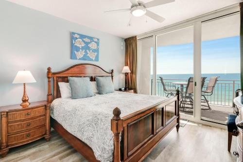 a bedroom with a bed and a balcony with the ocean at Aqua Resort in Panama City Beach