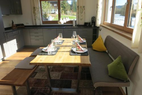 a wooden table with plates of food on it in a kitchen at Seebach Chalets in Scheffau am Wilden Kaiser