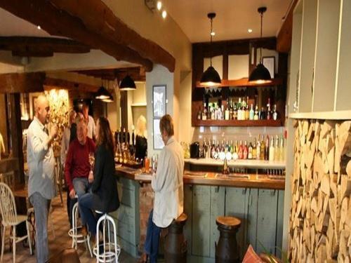 a group of people sitting at a bar at The Fox & Hounds in Swindon