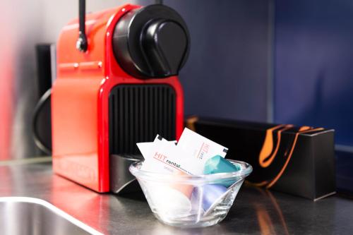 a cup of ice cream and a suitcase on a table at HITrental Allmend Standard Studios in Luzern