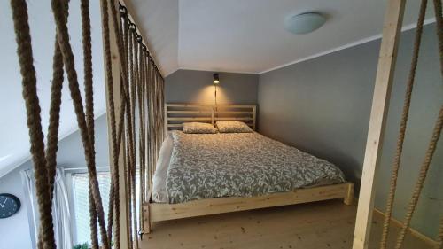 een slaapkamer met een bed met een houten schommel bij P.D.S APARTAMENT in Wisła