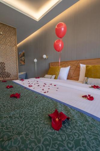 a bedroom with a bed with a red balloon on it at استراحة الفيحاء AL Feyhaa Resthouse in Samail