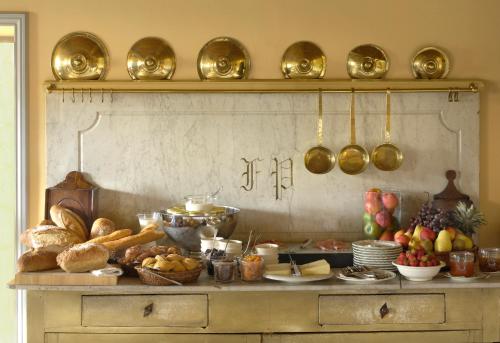 a table with a bunch of food on it at Le Mas de Peint - Hôtel et Restaurant in Le Sambuc