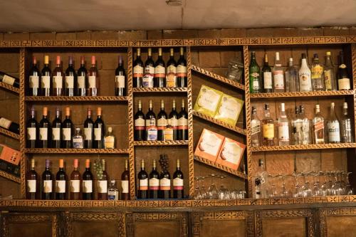 a display of wine bottles and glasses in a bar at Panoramic View Hotel in Lalībela