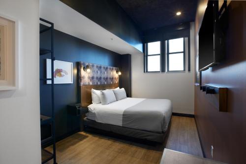 a bedroom with a large bed and a window at TRYP by Wyndham Pittsburgh/Lawrenceville in Pittsburgh