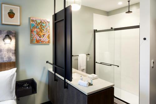 a bathroom with a sink and a mirror at TRYP by Wyndham Pittsburgh/Lawrenceville in Pittsburgh