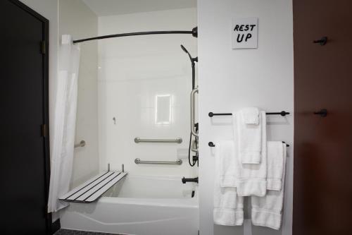 a bathroom with white towels and a bath tub at TRYP by Wyndham Pittsburgh/Lawrenceville in Pittsburgh