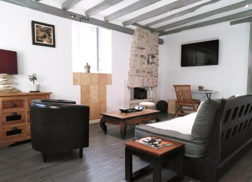uma sala de estar com uma cama, um sofá e uma mesa em Wood Stone and Wine em Beaune