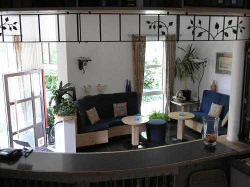 a living room with a couch and tables at Bed & Breakfast Bulligan in Lindau