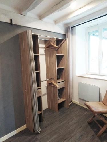 a room with a closet with shelves and a window at Wood Stone and Wine in Beaune