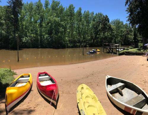 three kayaks sitting on the shore of a river at Rio Manso Tigre in Tigre