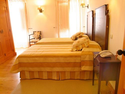 a bedroom with a large bed in a room at Casa de Campo Sao Rafael - Turismo Rural in Óbidos
