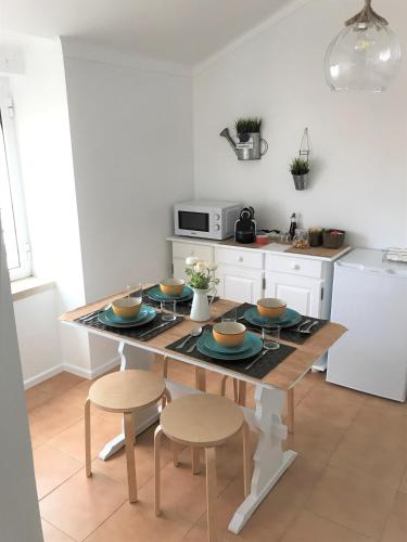 a kitchen with a table with dishes on it at BonitaBay in São Martinho do Porto