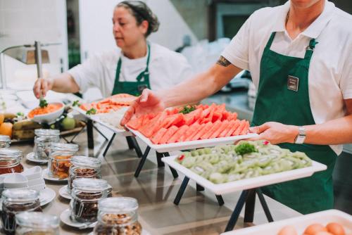 two chefs preparing food in a kitchen at Pestana Churchill Bay in Câmara de Lobos