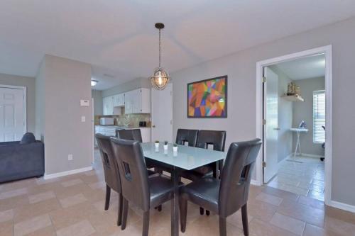 a dining room with a table and chairs at Ybor Casita! 3-Bedrooms Steps away from Centro Ybor! in Tampa