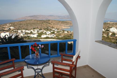 a balcony with a table and chairs and a view at Aiolos Iraklia in Iraklia