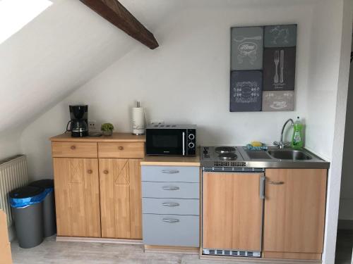 a small kitchen with a sink and a microwave at Studio Apartment in Alsdorf