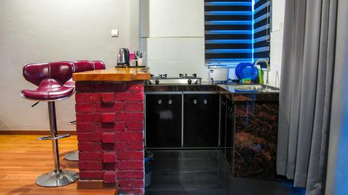 a kitchen with a red brick counter and a sink at Andalus beach residence in Marang