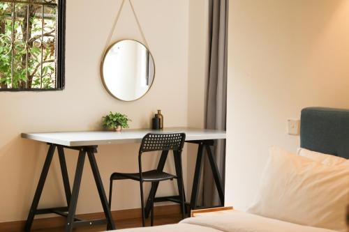 a desk in a bedroom with a chair and a mirror at IKO homes in Kota Kinabalu