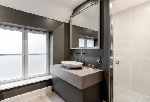 a bathroom with a sink and a mirror at Gorse Hill Hotel in Woking