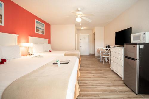 a hotel room with two beds and a kitchen at Island Sun Inn & Suites - Venice, Florida Historic Downtown & Beach Getaway in Venice